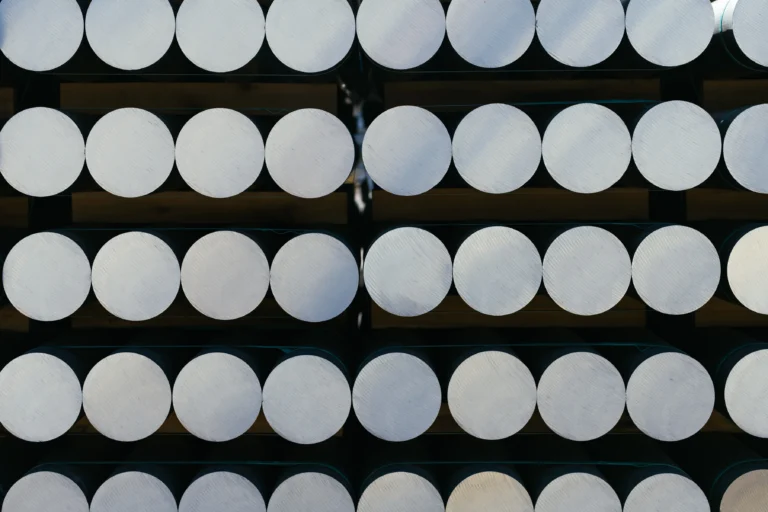 Several large aluminum billets bound together on pallets.